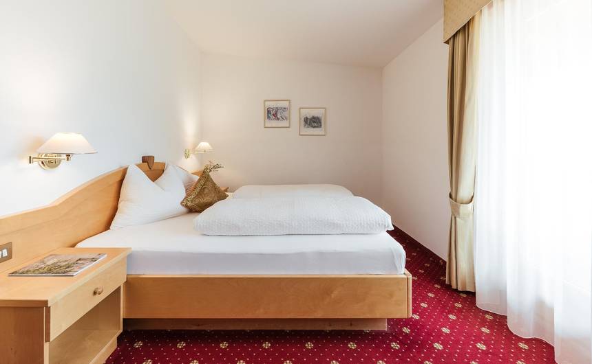 Modernes Hotelzimmer im Hotel Bauhof in Kastelbell, Südtirol mit Doppelbett und Balkon Modernes Hotelzimmer im Hotel Bauhof in Kastelbell, Südtirol mit Doppelbett und Balkon