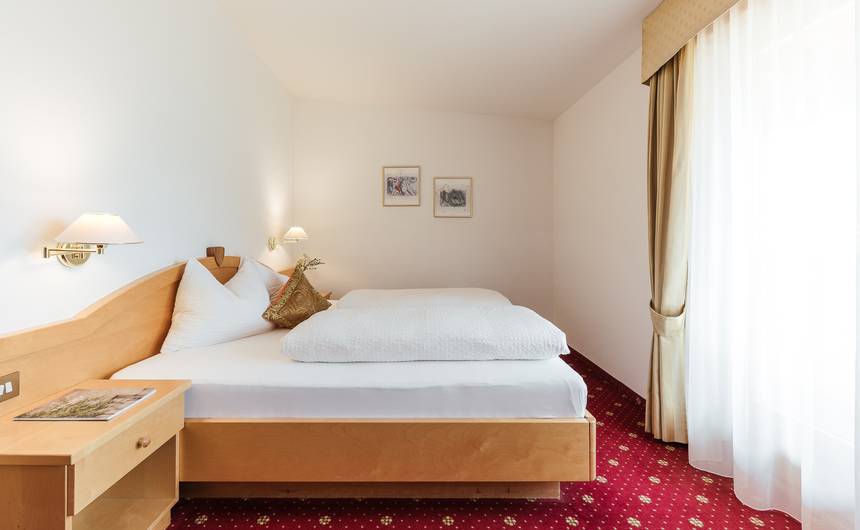 Modern hotel room Juval with double bed and mountain view at Hotel Bauhof in South Tyrol